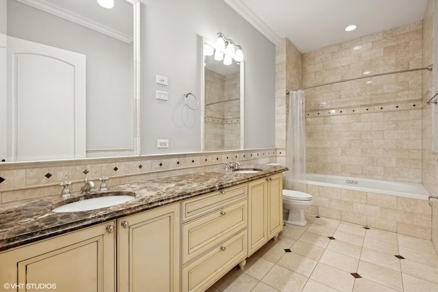 bathroom featuring tiled shower / bath, ornamental molding, tile patterned flooring, and a sink