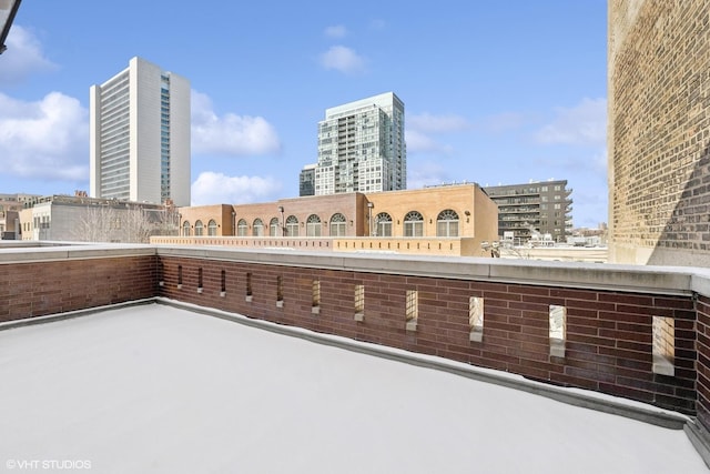 view of patio / terrace with a balcony and a view of city