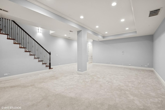 finished basement featuring stairs, baseboards, visible vents, and recessed lighting