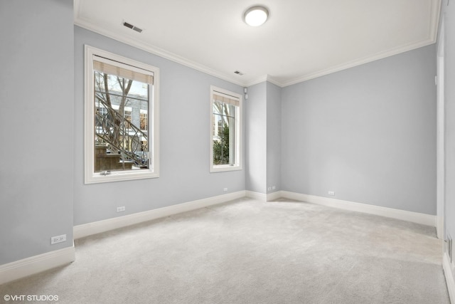 unfurnished room featuring light carpet, crown molding, visible vents, and baseboards