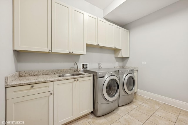 laundry room with cabinet space, light tile patterned flooring, a sink, washer and dryer, and baseboards