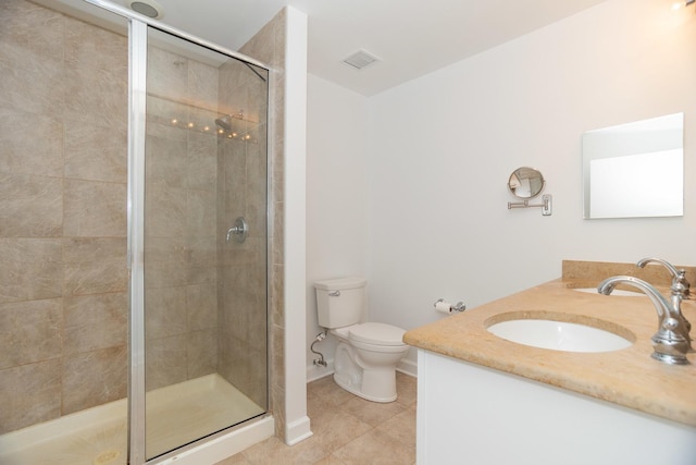 bathroom featuring tile patterned floors, vanity, toilet, and an enclosed shower