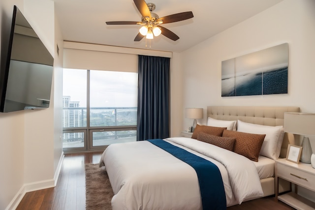 bedroom with dark hardwood / wood-style flooring and ceiling fan