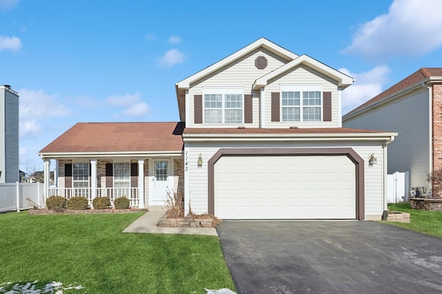 front of property featuring a front yard, a garage, and a porch