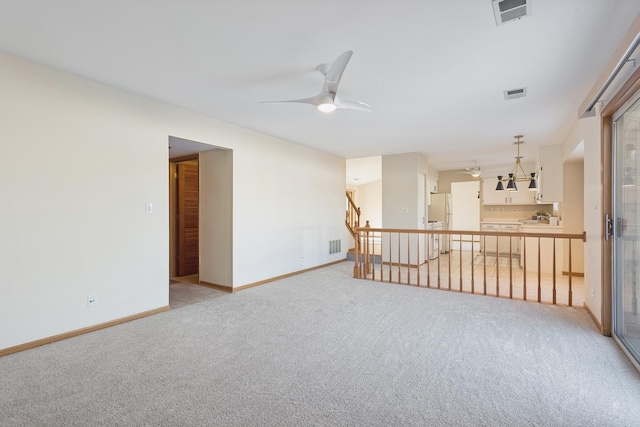 carpeted empty room with ceiling fan