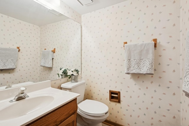 bathroom with toilet and vanity