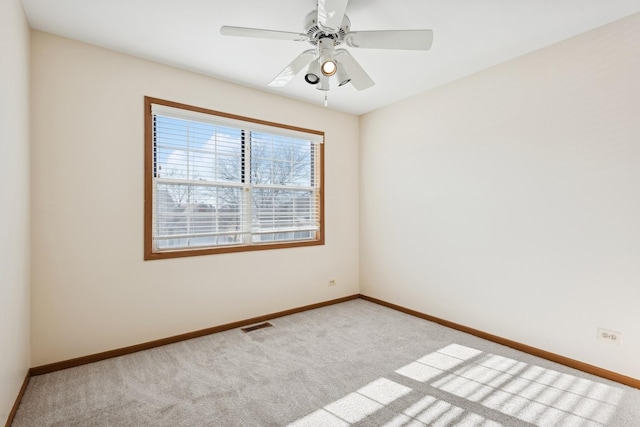 empty room featuring light carpet and ceiling fan