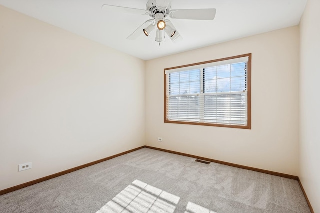 unfurnished room featuring ceiling fan and light colored carpet