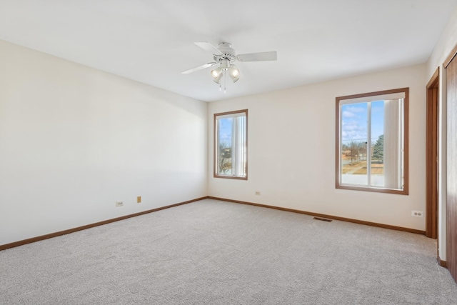 carpeted empty room featuring ceiling fan