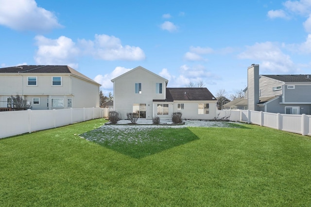 rear view of property featuring a lawn