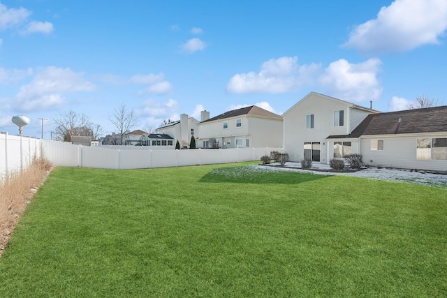 rear view of house featuring a yard