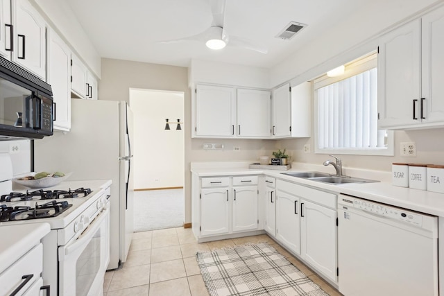 kitchen featuring white appliances, white cabinets, sink, ceiling fan, and light tile patterned floors