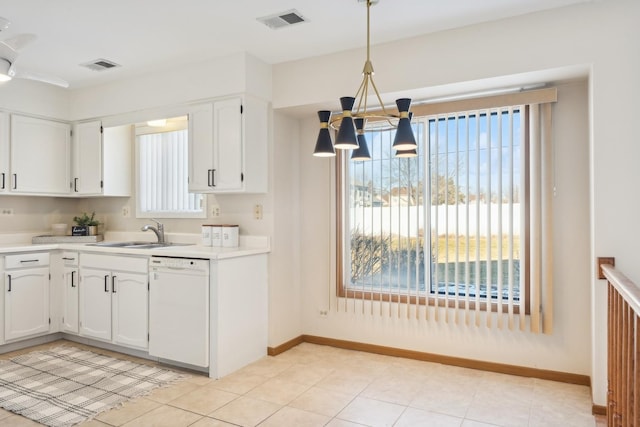 kitchen featuring white cabinetry, decorative light fixtures, light tile patterned flooring, white dishwasher, and sink