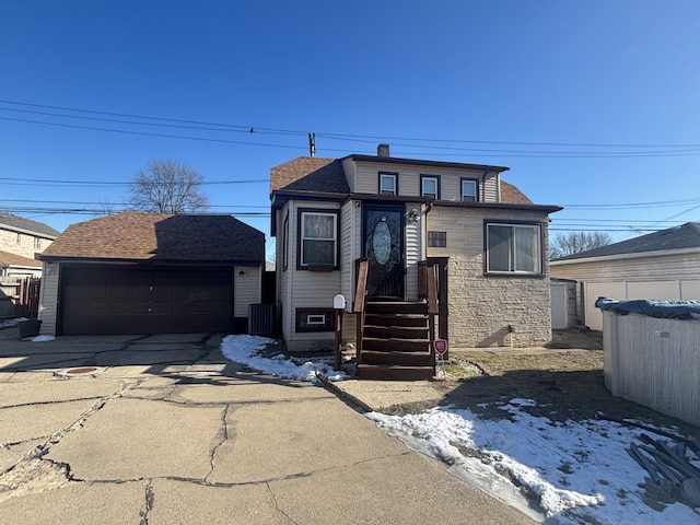 view of front facade featuring a garage and an outbuilding