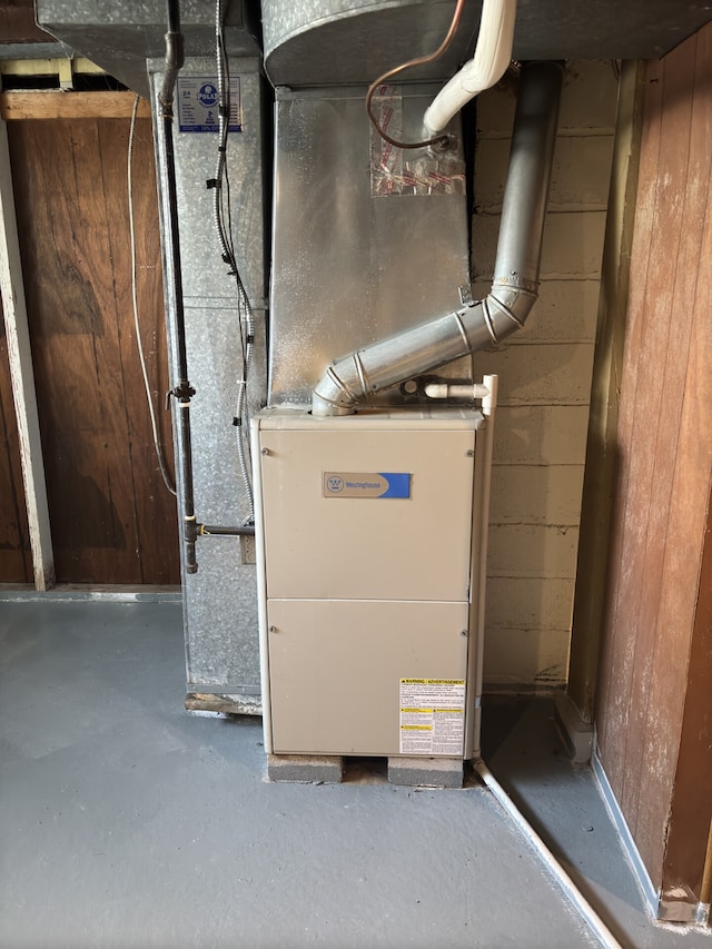 utility room featuring heating unit