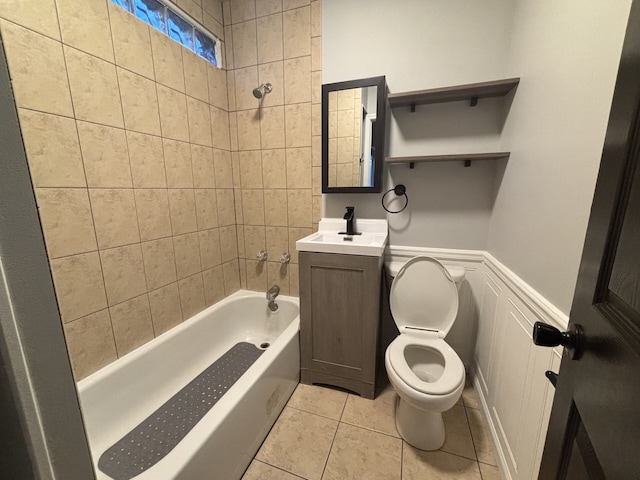 full bathroom with toilet, tile patterned flooring, tiled shower / bath, and vanity