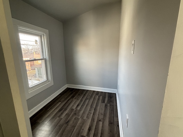 unfurnished room featuring dark wood-type flooring