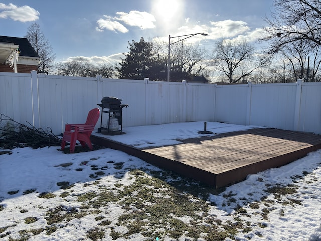 yard covered in snow with a deck