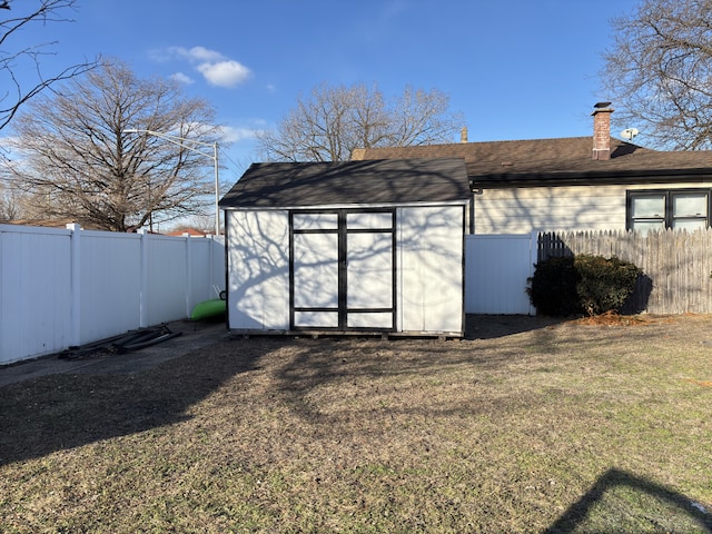 view of outbuilding with a yard