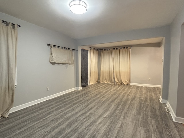 empty room with dark hardwood / wood-style floors