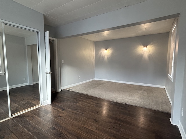 spare room with dark wood-type flooring