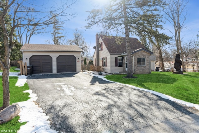 view of front of property featuring a garage and a front yard