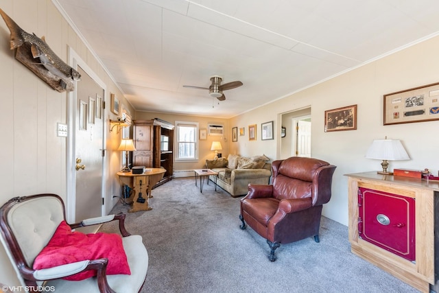 carpeted living room featuring crown molding, a wall mounted AC, and ceiling fan