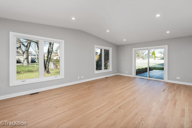 interior space with lofted ceiling and light wood-type flooring