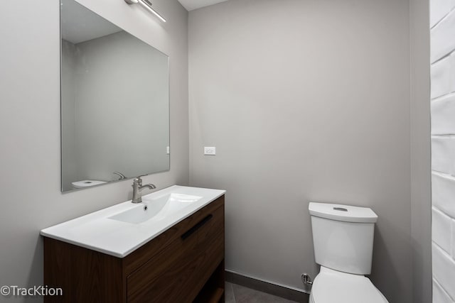 bathroom featuring toilet and vanity