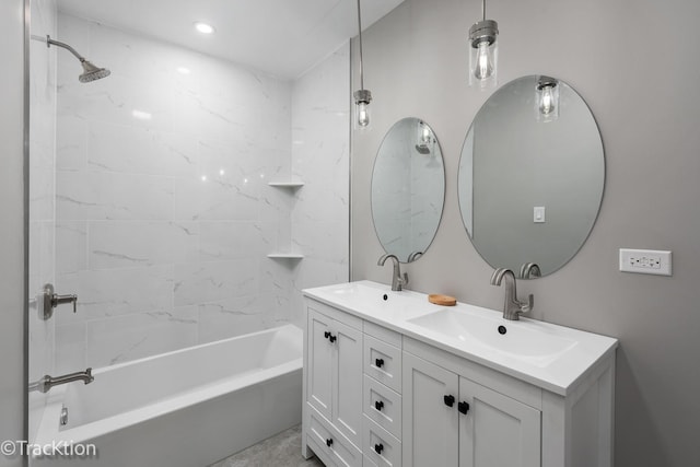 bathroom featuring tiled shower / bath combo and vanity