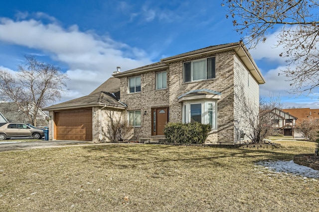 view of front of property featuring a front yard and a garage