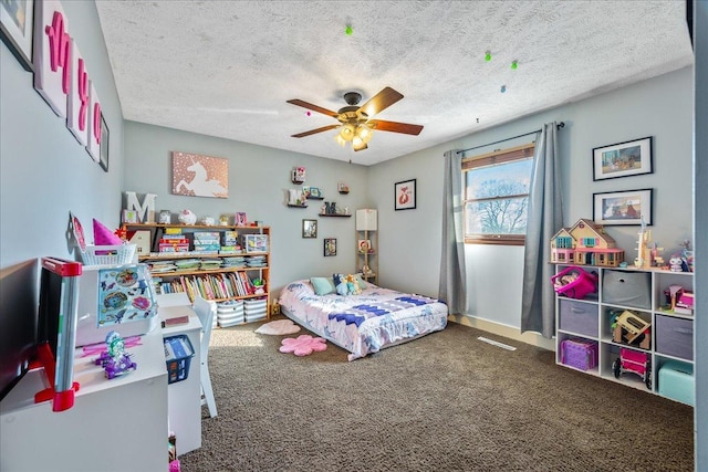 bedroom featuring a textured ceiling, carpet flooring, and ceiling fan