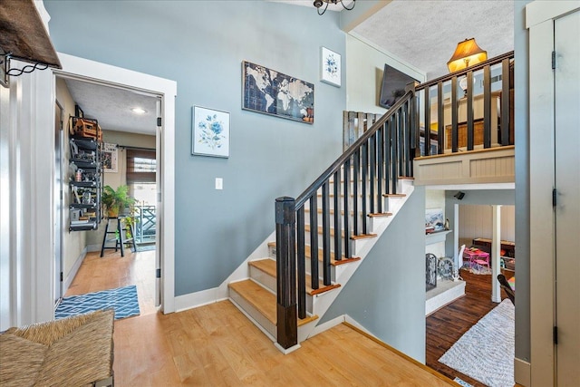 staircase with hardwood / wood-style flooring