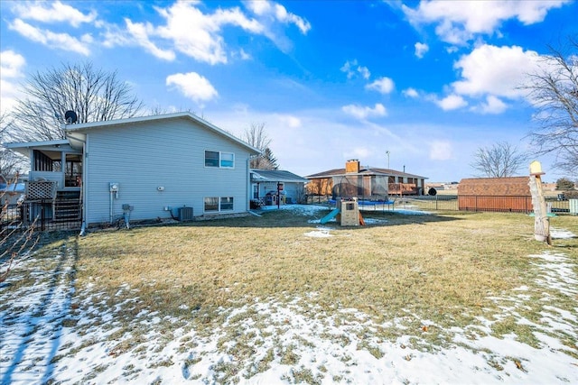 snow covered property with a gazebo, a lawn, and a trampoline