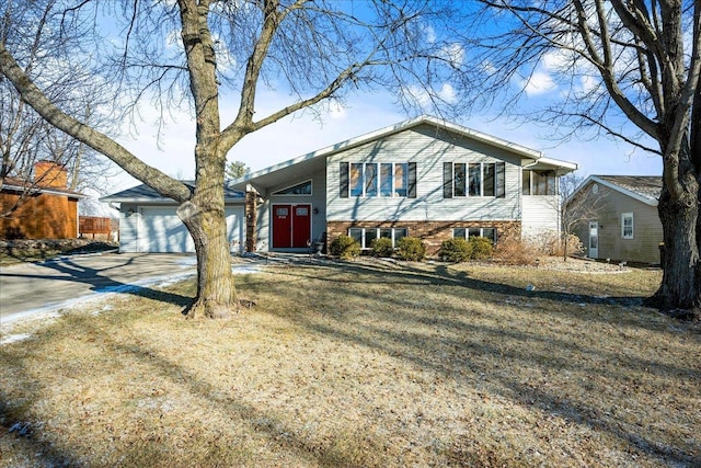 view of front facade with a garage and a front lawn