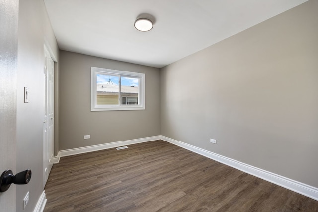 unfurnished room with dark hardwood / wood-style floors