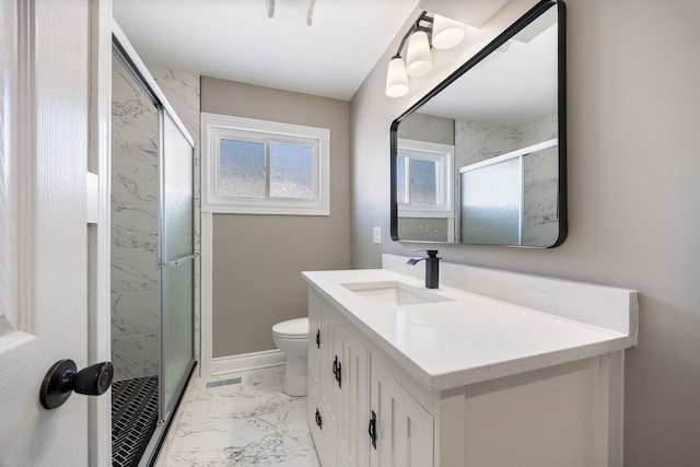 bathroom featuring toilet, vanity, and an enclosed shower