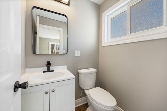 bathroom featuring toilet and vanity