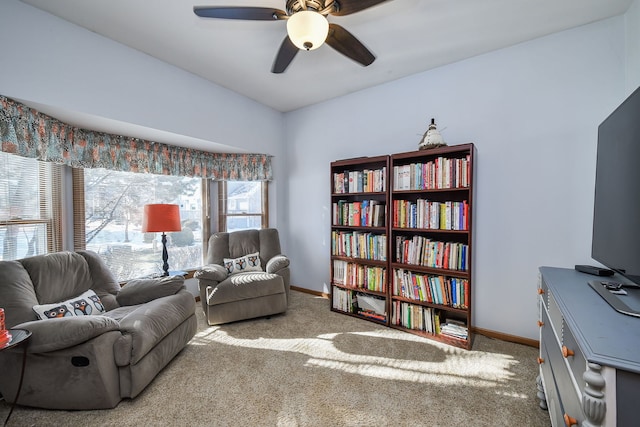 living area with carpet floors and ceiling fan