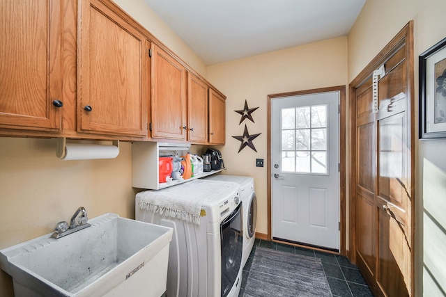 laundry area with washer and dryer, sink, cabinets, and dark tile patterned floors