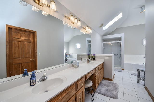 bathroom with vanity, vaulted ceiling with skylight, separate shower and tub, and tile patterned flooring