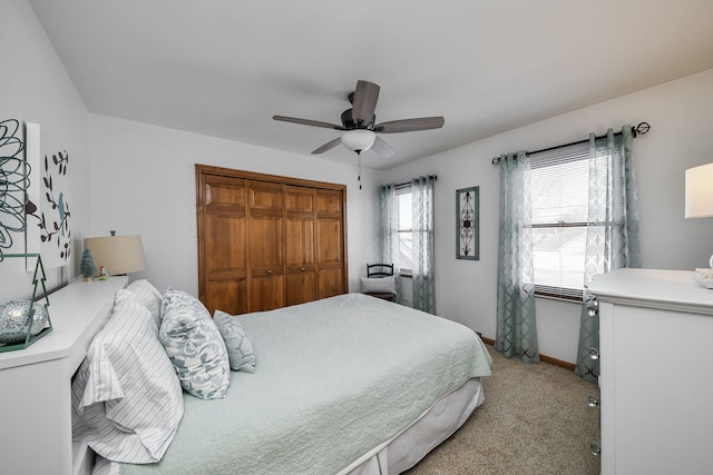 carpeted bedroom featuring a closet and ceiling fan