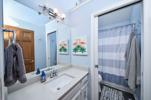 bathroom with vanity, curtained shower, and toilet