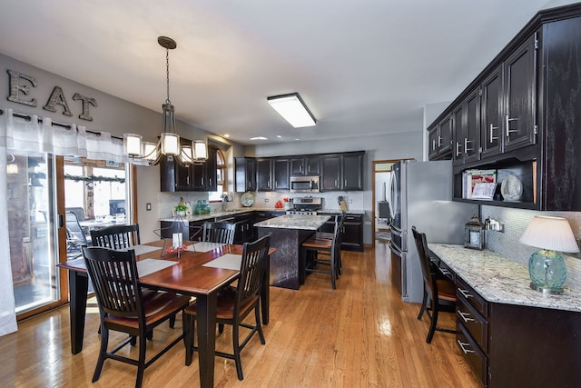 dining room featuring sink and light hardwood / wood-style flooring