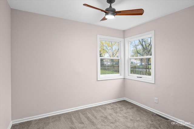 spare room with ceiling fan and carpet flooring