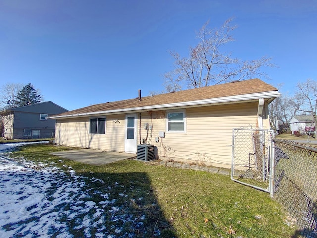 rear view of house with a patio area, a yard, and central air condition unit