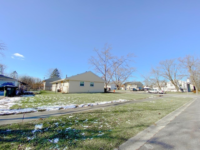 view of side of property with a yard