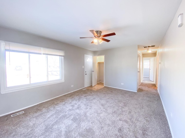 carpeted empty room with ceiling fan