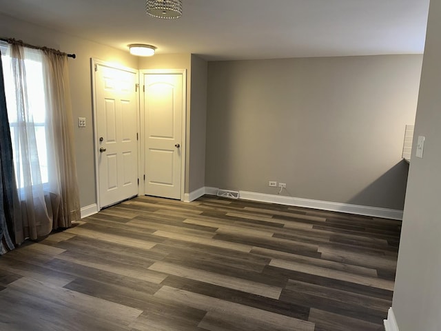 spare room featuring dark hardwood / wood-style flooring