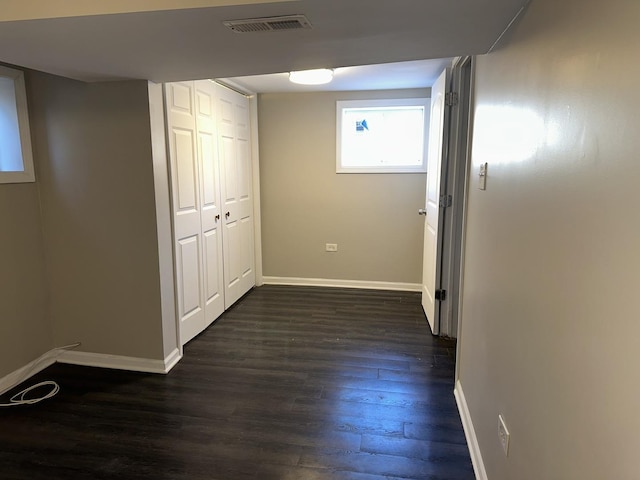 hallway with dark hardwood / wood-style floors